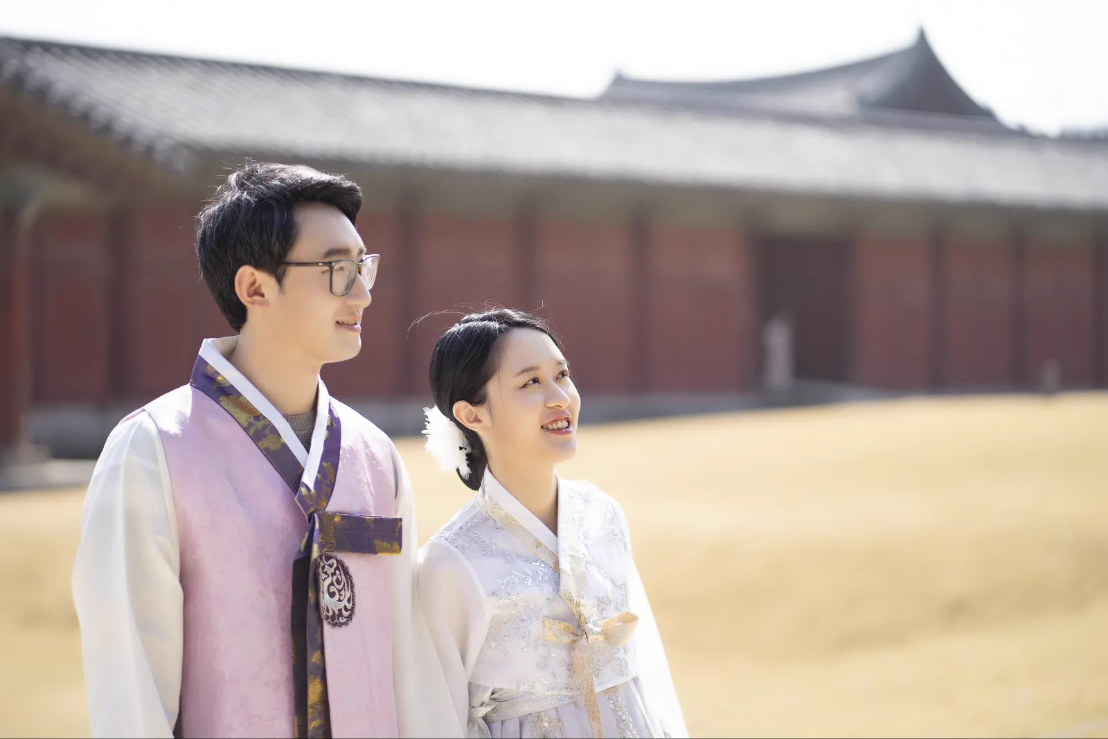 A couple walking through a palace courtyard at Changgyeonggung