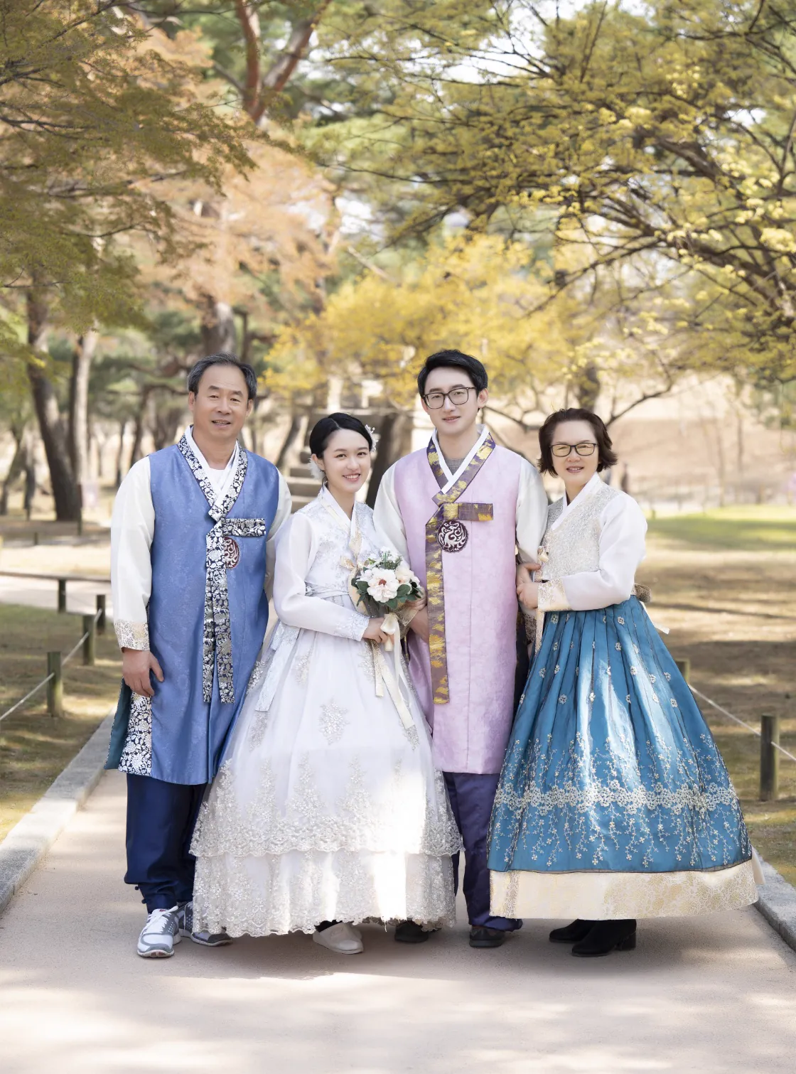 A formal family portrait in hanbok during a palace photo session