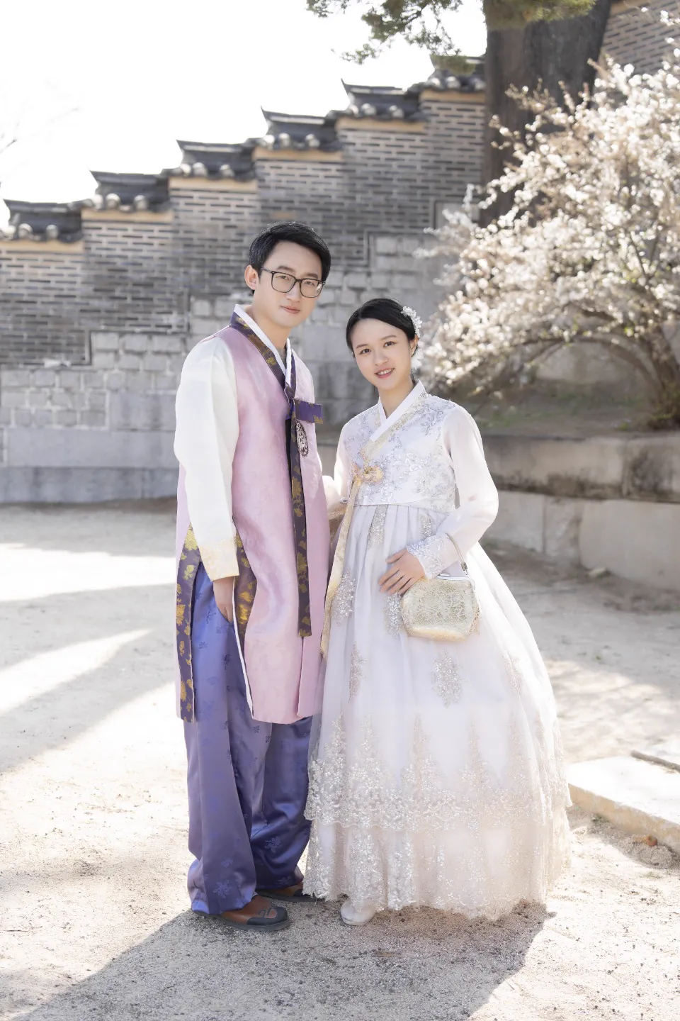 A couple portrait beside a palace stone wall in Seoul